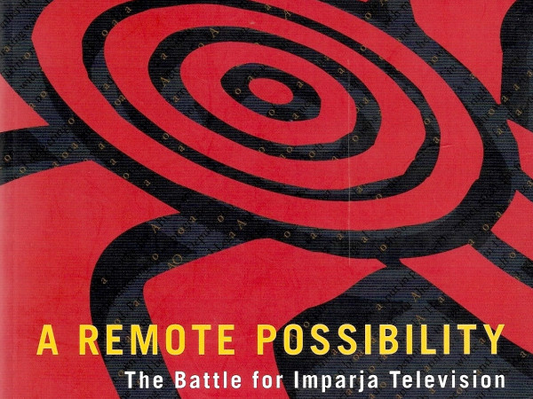 Red and white front cover for book, with yellow writing - A Remote Possibilty, the battle for Imparja Television